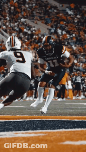 A Miners Football Player Runs With The Ball As A Player With The Number 9 Tries To Tackle Him GIF