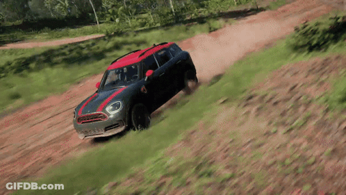 A Mini Cooper Is Driving Down A Dirt Road In A Video Game GIF
