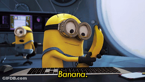 Minion Holding Banana In Front Of Keyboard GIF