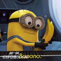 Minion Holding Banana In Front Of Keyboard GIF