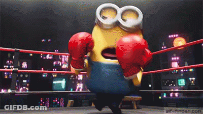 A Minion Is Wearing Red Boxing Gloves In A Ring . GIF