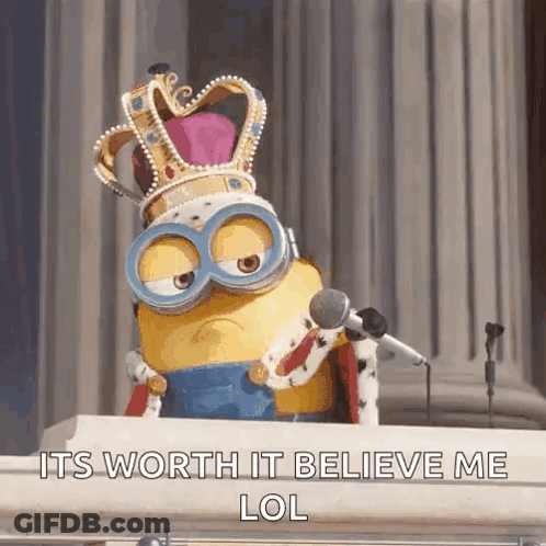 A Minion Wearing A Crown And Goggles Is Sitting At A Podium With A Microphone .. GIF