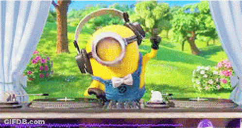 A Minion Wearing Headphones And Goggles Is Standing In Front Of A Table . GIF