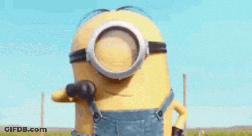 A Minion Wearing Overalls And Goggles Is Giving The Middle Finger . GIF