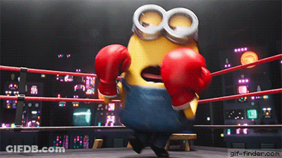 A Minion Wearing Red Boxing Gloves Is In A Ring GIF
