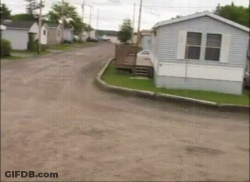 A Mobile Home Sits On The Side Of A Road GIF