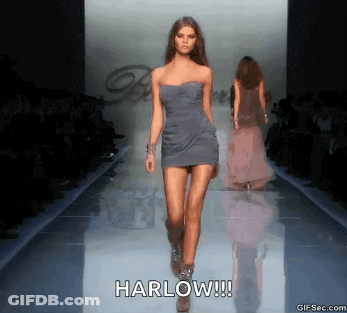 A Model Walks Down A Runway At A Fashion Show With The Caption Harlow !!! GIF