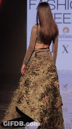 A Model Walks Down The Runway At A Fashion Week GIF