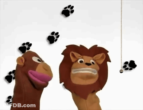 A Monkey And A Lion Puppet Are Standing Next To Each Other With Paw Prints Behind Them GIF