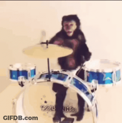 A Monkey Is Playing A Drum Set On A White Background . GIF