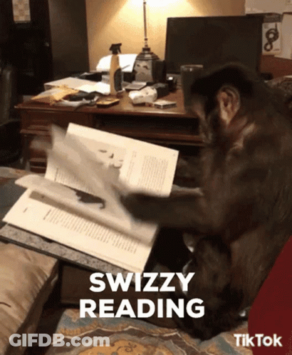 A Monkey Is Reading A Book With The Words Swizzy Reading Below It GIF