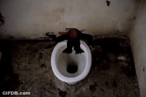 A Monkey Is Sitting On A Toilet With A Toothbrush . GIF