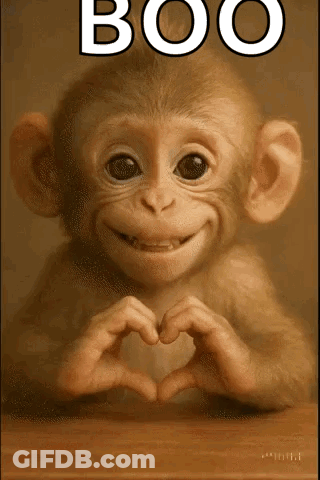 A Monkey Making A Heart Shape With Its Hands With The Word Boo Above It GIF