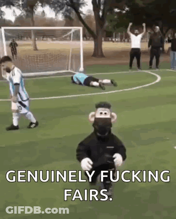 A Monkey Mascot Is Standing On A Soccer Field Next To A Goalie . GIF