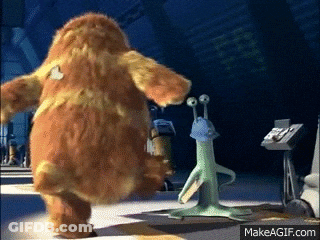 A Monster From The Movie Monsters Inc Is Standing Next To A Green Alien GIF