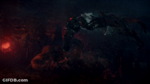 A Monster Is Fighting Another Monster In A Dark Scene GIF