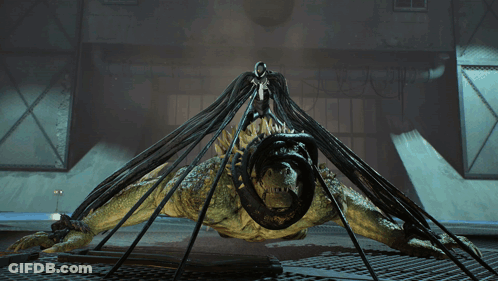 A Monster With A Snake In Its Mouth Is Being Lifted By A Person GIF