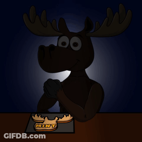 A Moose Sitting At A Table With A Mint Cookie On It 'S Head GIF