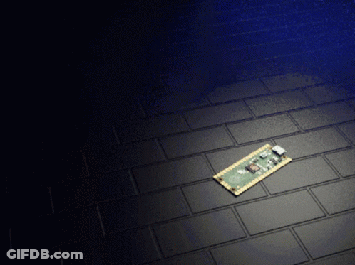 A Motherboard Is Laying On A Black Tile Floor GIF