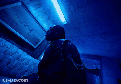 A Motorcycle Is Parked In The Dark With A Person Standing Behind It GIF