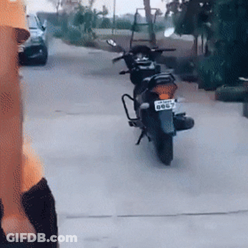 A Motorcycle Is Parked On The Side Of The Road And Has A License Plate That Says Bb67 GIF
