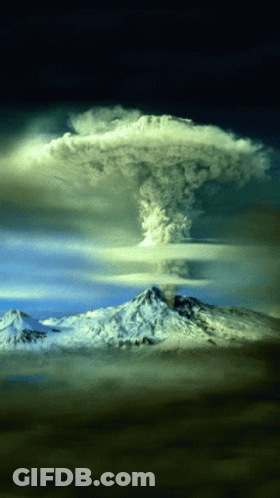 A Mountain With Smoke Coming Out Of It And A Cloud Above It GIF