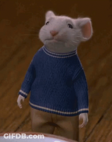 A Mouse Wearing A Blue Sweater Is Waving His Hand GIF