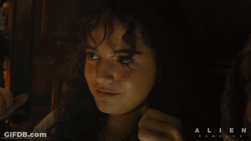 A Movie Poster For Alien Romulus Shows A Woman Giving The Thumbs Up GIF