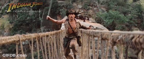 A Movie Poster For Indiana Jones Shows A Man Crossing A Bridge GIF