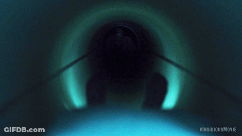 A Movie Poster For The Insidious Movie Shows A Man In A Hospital Gown Crawling Through A Tunnel GIF