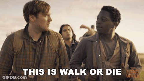 A Movie Poster For The Long Walk Shows Two Men Standing Next To Each Other And Says This Is Walk Or Die GIF