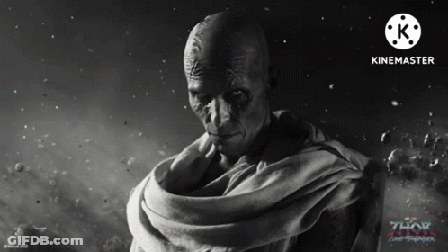 A Movie Poster For Thor Ragnarok Shows A Bald Man With A Scarf Around His Neck GIF