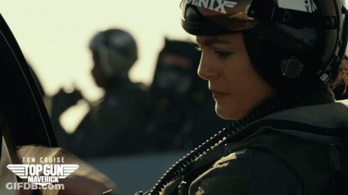 A Movie Poster For Top Gun Maverick Shows A Woman Wearing A Helmet And Goggles GIF