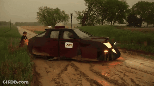 A Muddy Road With A Car That Has A Sticker On It That Says ' Texas ' GIF