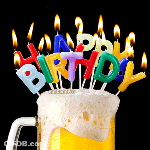 A Mug Of Beer With Birthday Candles On Top GIF