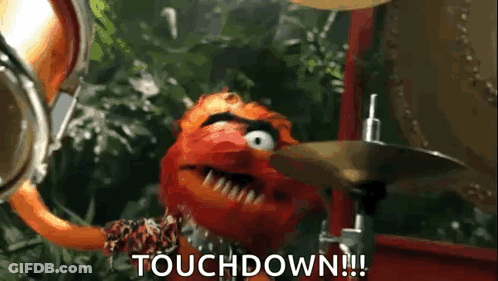 A Muppet Is Playing Drums And Says Touchdown . GIF