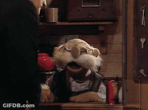 A Muppet Is Sitting At A Table With A Can Of Popeye 'S GIF