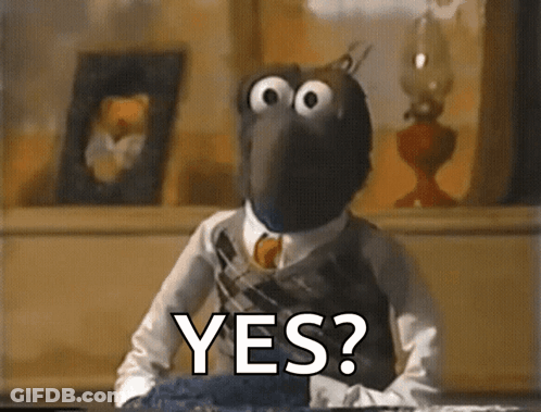 A Muppet Is Sitting At A Table With The Words Yes Written On It GIF