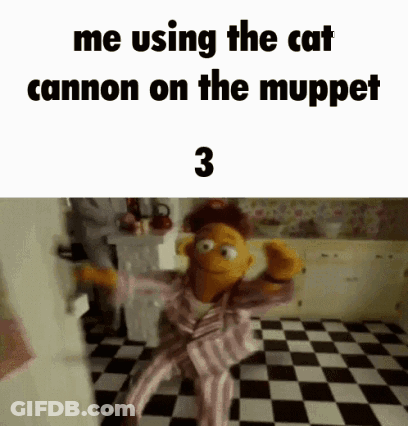 A Muppet Is Sitting On A Checkered Floor In A Kitchen And Using The Cat Cannon On The Muppet Show . GIF
