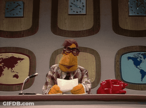 A Muppet Sitting At A Desk With A Piece Of Paper In Front Of Him GIF