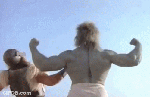 A Muscular Man Is Flexing His Muscles While Standing Next To Another Man . GIF