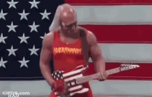 A Muscular Man Is Playing A Guitar In Front Of An American Flag . GIF