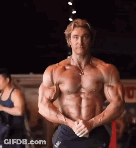 Muscular Man Posing In Gym With Hands On Hips GIF