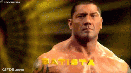 A Muscular Man With The Name Batista Written On His Chest GIF