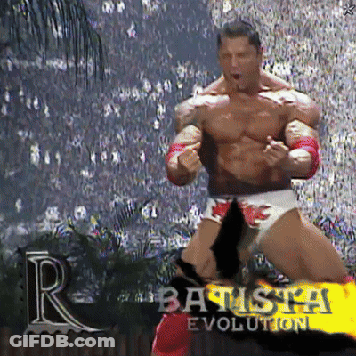 A Muscular Wrestler Is Standing In Front Of A Crowd And The Words Batista Evolution Are On The Screen GIF