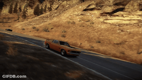 A Mustang Is Driving Down A Road In The Desert GIF