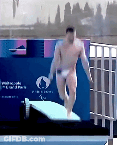 A Naked Man Is Jumping Into A Pool With A Sign That Says Metropole Grand Paris On It GIF