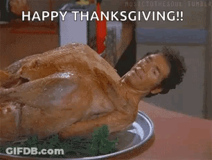A Naked Man Is Laying On A Plate Of Food With The Words `` Happy Thanksgiving '' . GIF