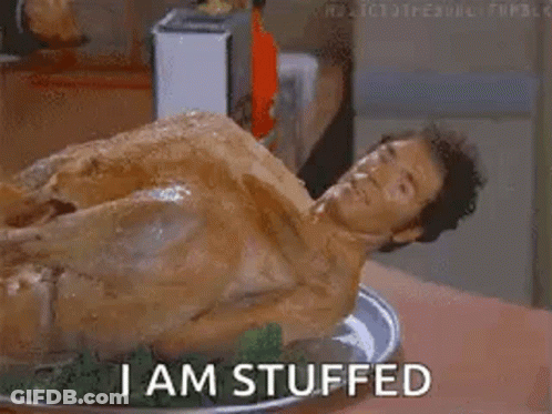 A Naked Man Is Laying On A Plate Of Stuffed Turkey And Says `` I Am Stuffed '' . GIF