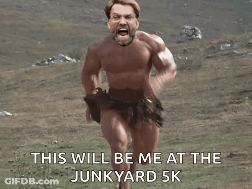 A Naked Man Is Running In A Field With The Words This Will Be Me At The Junkyard 5K Below Him GIF